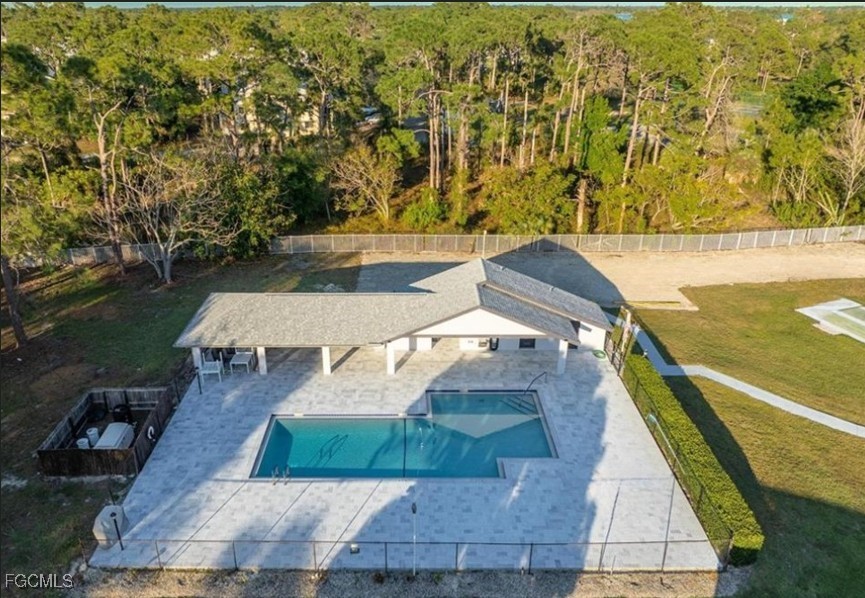 10615 Roxbury Court Lehigh Acres, FL 33936 - Photo 27 of 33 swimming pool view with a sitting space