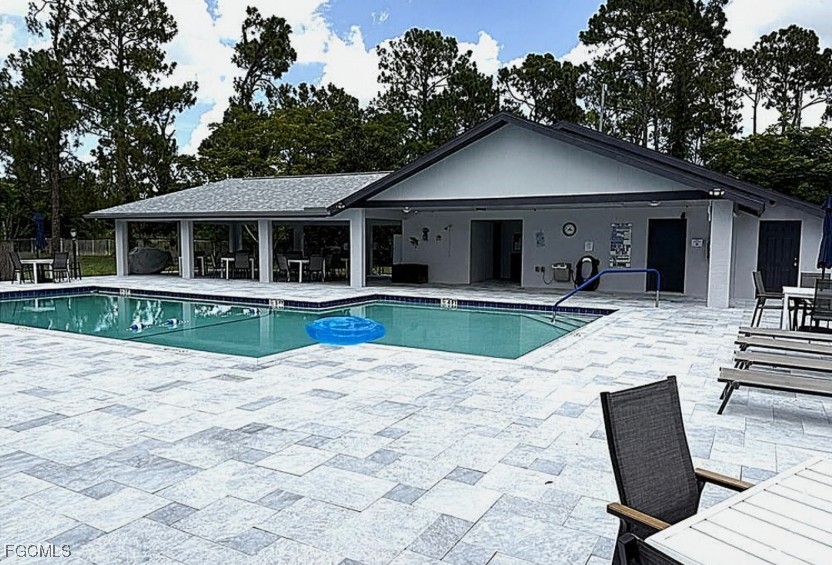 10615 Roxbury Court Lehigh Acres, FL 33936 - Photo 28 of 33 a view of a house with a yard and large tree