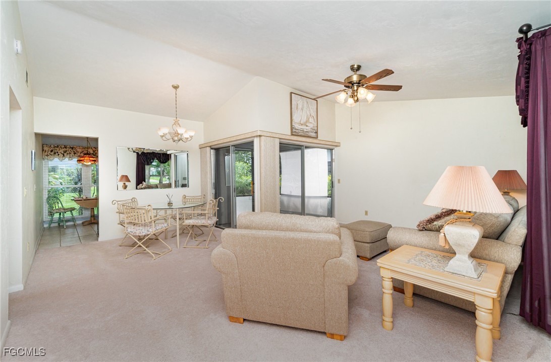 10615 Roxbury Court Lehigh Acres, FL 33936 - Photo 6 of 33 a living room with furniture a chandelier and a window