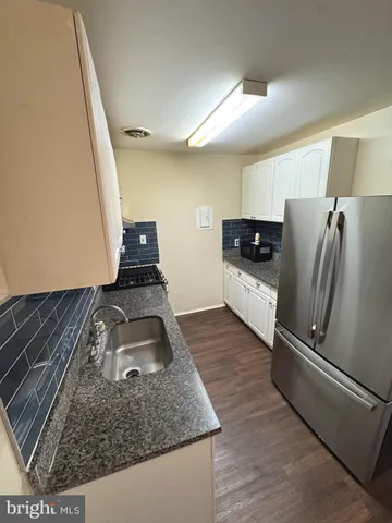 a kitchen with sink refrigerator and stove