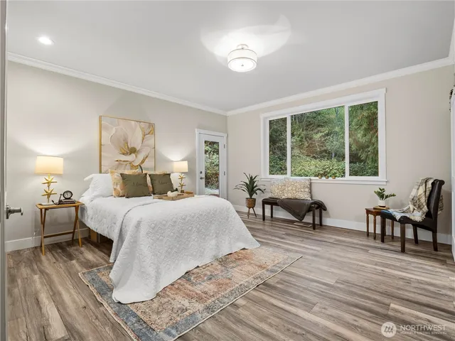 a bedroom with double bed and a large window