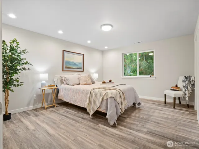 a bedroom with a bed and a potted plant