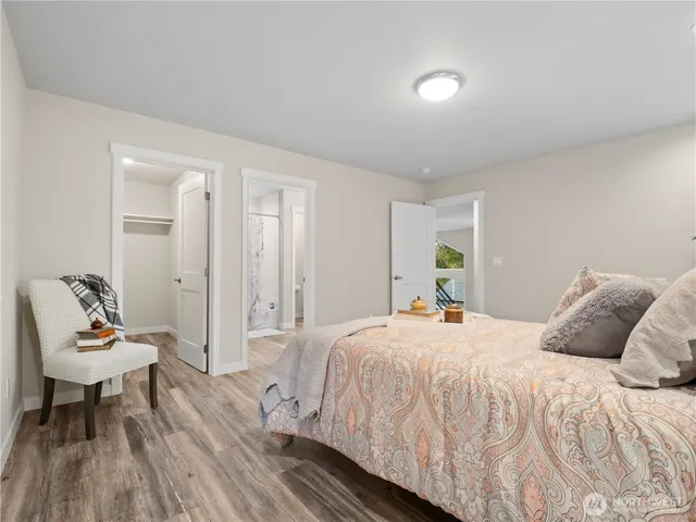 a bedroom with a bed and wooden floor