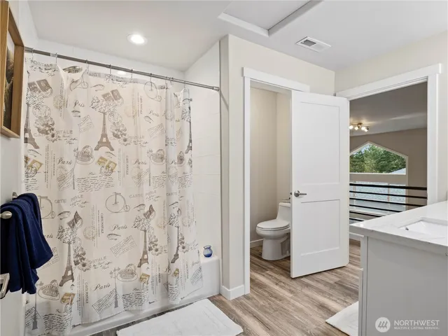 a bathroom with a shower toilet and sink