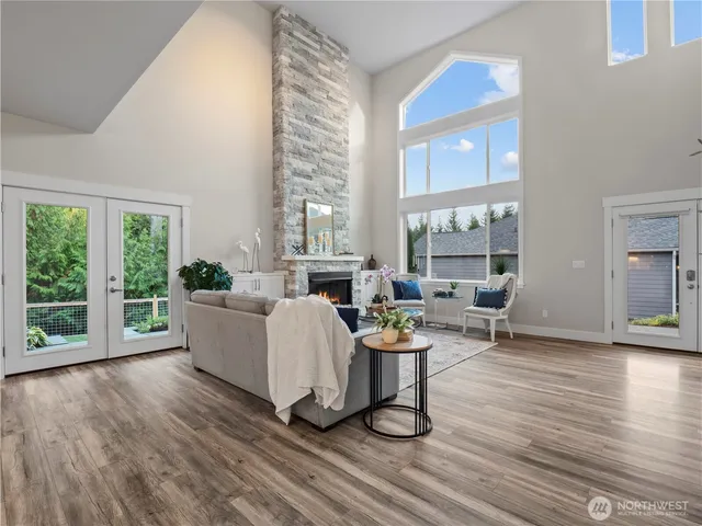 a living room with fireplace furniture and a large window