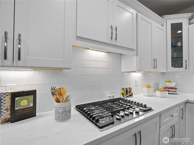 a kitchen with a stove and cabinets