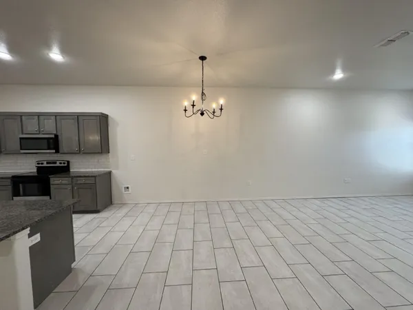 a view of a kitchen with microwave and cabinets