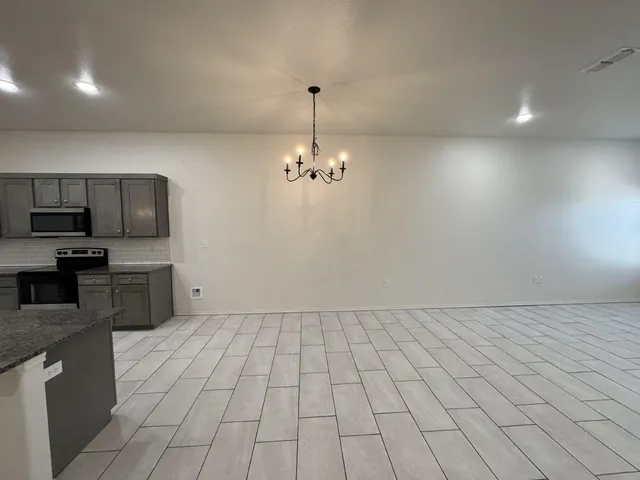 a view of a kitchen with microwave and cabinets