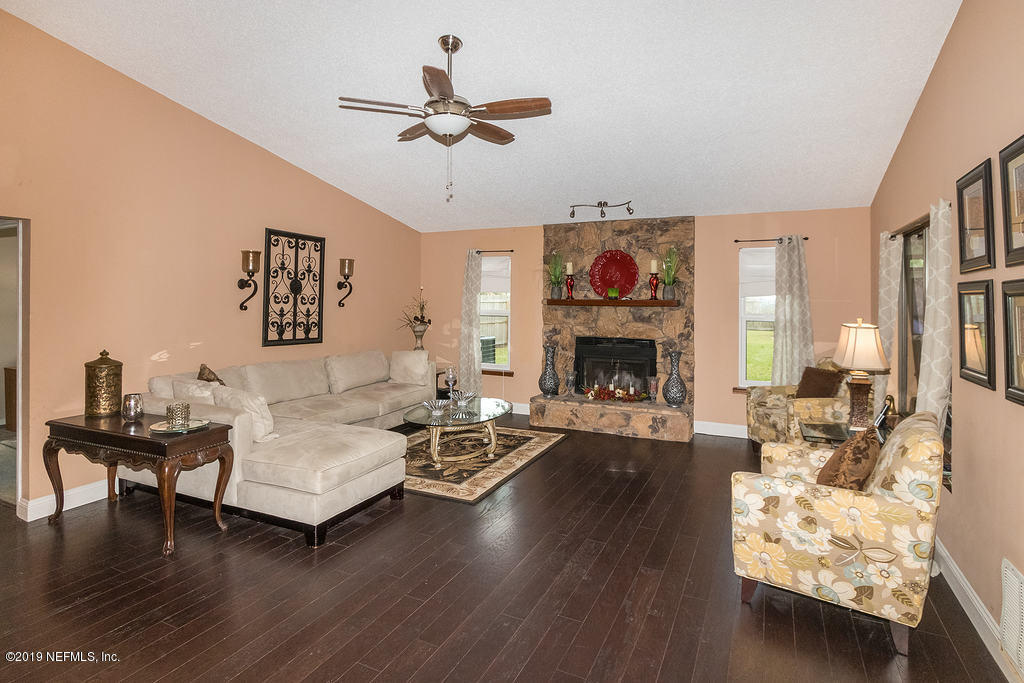 11012 Reading Road Jacksonville, FL 32257 - Photo 11 of 29 a living room with furniture and a fireplace