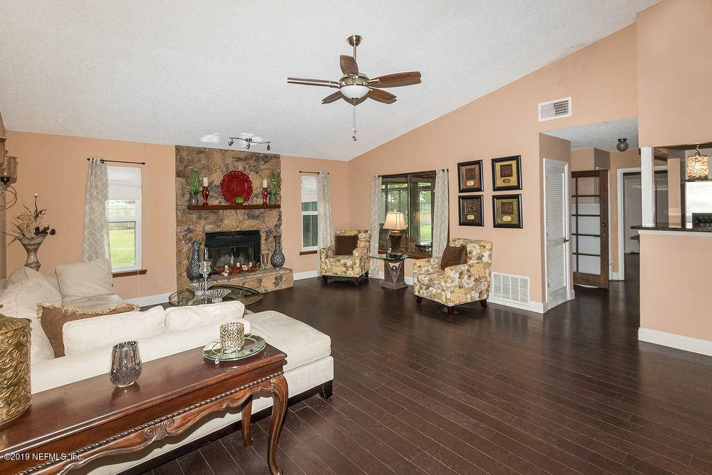 11012 Reading Road Jacksonville, FL 32257 - Photo 12 of 29 a living room with furniture fireplace and a table