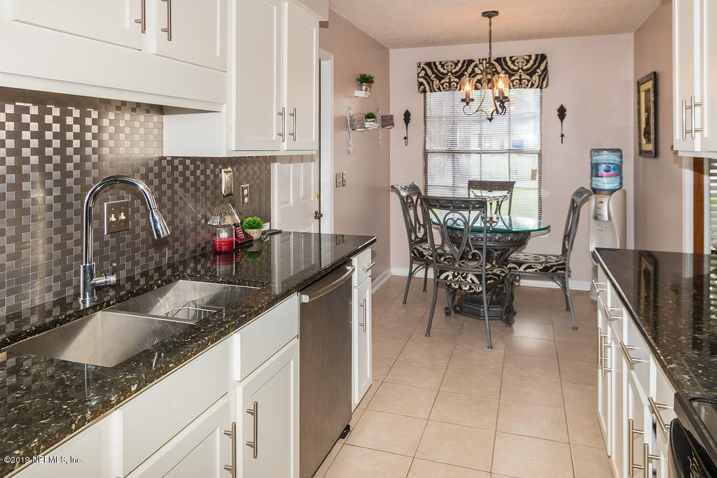 11012 Reading Road Jacksonville, FL 32257 - Photo 14 of 29 a kitchen with granite countertop stainless steel appliances a sink dishwasher a refrigerator and a counter space