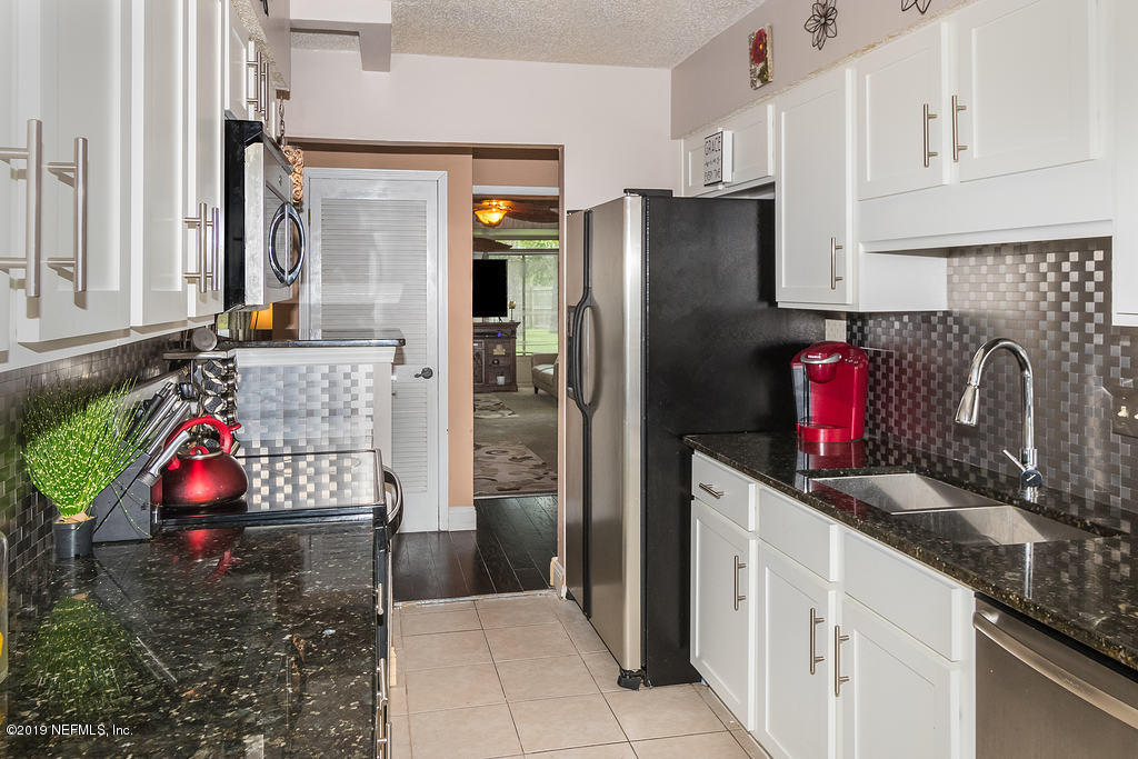 11012 Reading Road Jacksonville, FL 32257 - Photo 15 of 29 a kitchen with refrigerator and cabinets