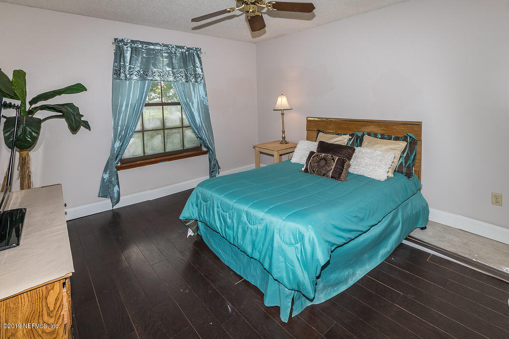 11012 Reading Road Jacksonville, FL 32257 - Photo 22 of 29 a bedroom with a bed and a window
