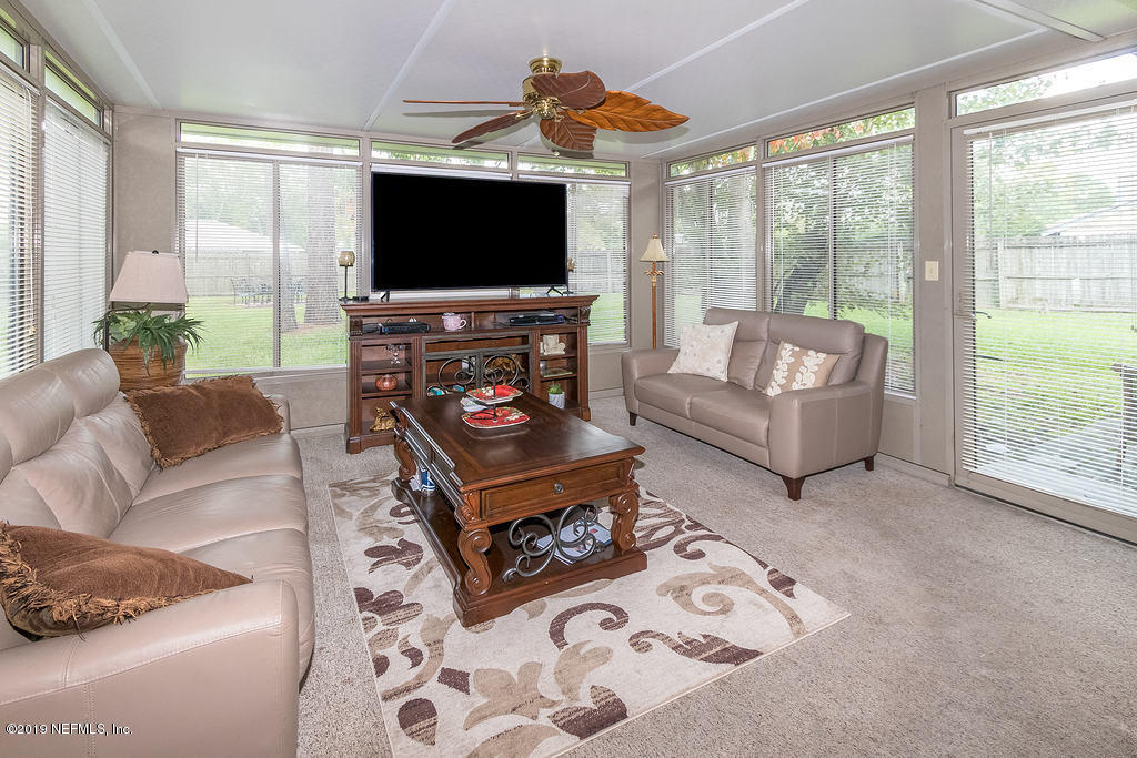 11012 Reading Road Jacksonville, FL 32257 - Photo 23 of 29 a living room with furniture and a flat screen tv