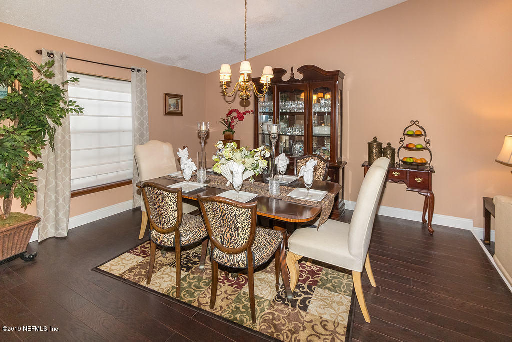 11012 Reading Road Jacksonville, FL 32257 - Photo 8 of 29 a view of a dining room with furniture and wooden floor