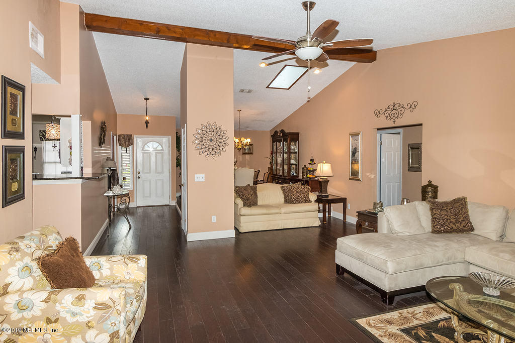 11012 Reading Road Jacksonville, FL 32257 - Photo 9 of 29 a living room with furniture and a wooden floor