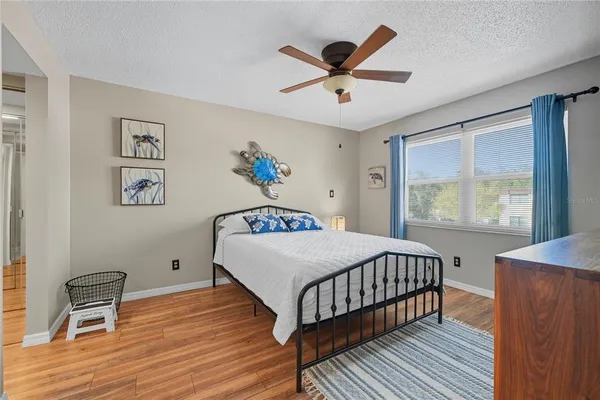 a bedroom with a bed and a large window