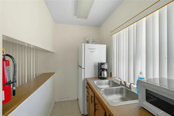 a bathroom with a granite countertop sink and a large mirror