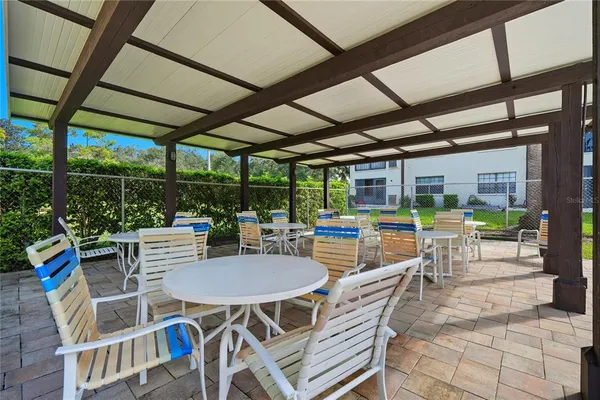 a view of a patio with a table and chairs next to a yard