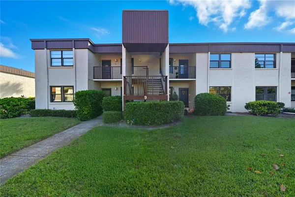 a view of a brick building next to a yard