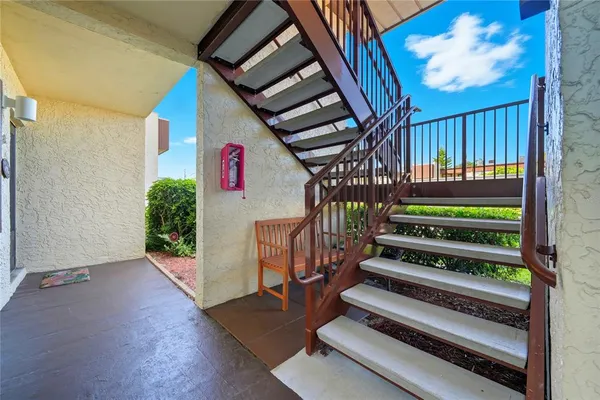 a view of front door with wooden floor and stairs