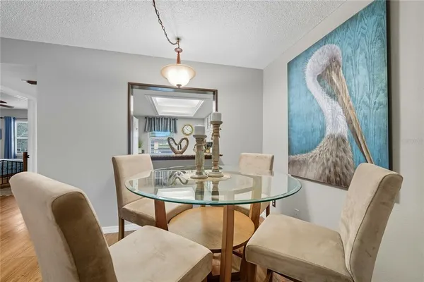 a dining room with furniture and wooden floor