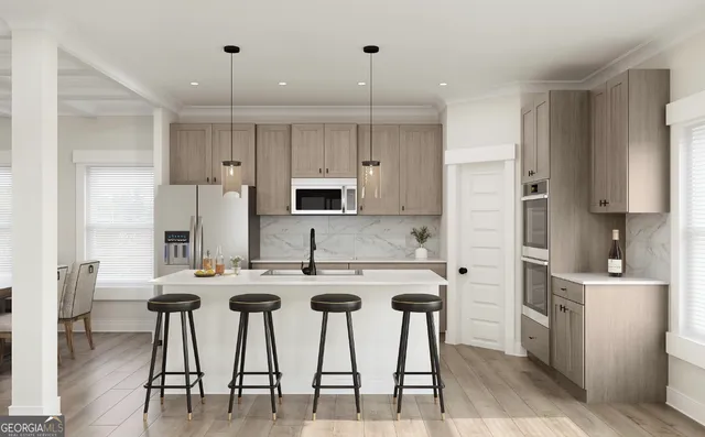 a kitchen with stainless steel appliances kitchen island granite countertop a table chairs microwave and sink