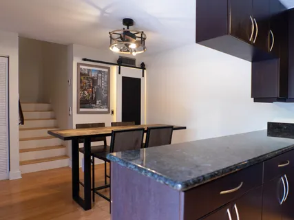 a kitchen with a table and chairs