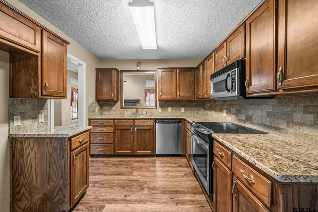 an empty room with a wooden floor and a window