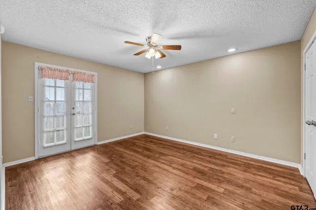 a view of an empty room with wooden floor