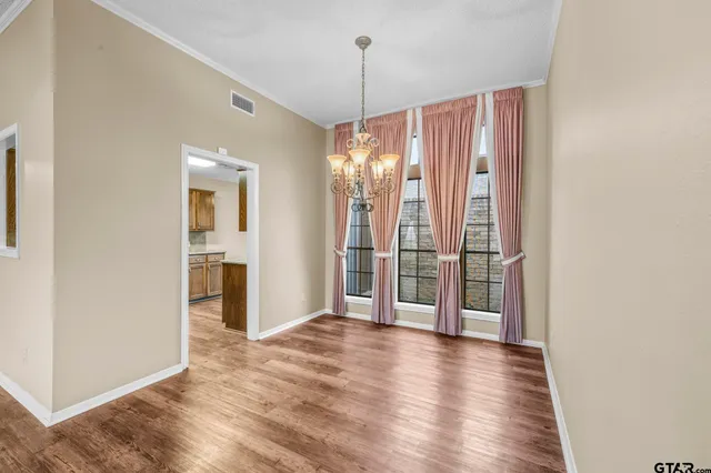 a view of a room with floor to ceiling window and wooden floor