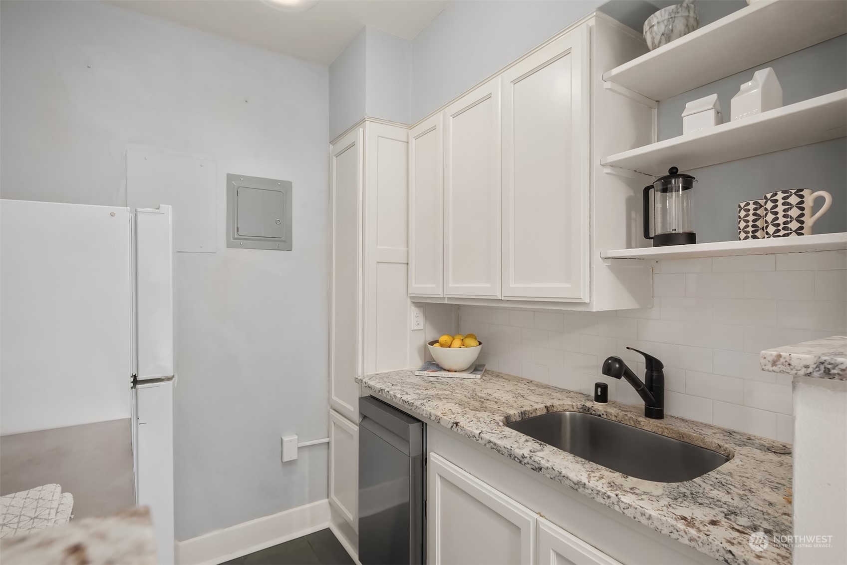 1605 East Olive Street, Unit 208 Seattle, WA 98122 - Photo 13 of 28 a kitchen with a sink and cabinets