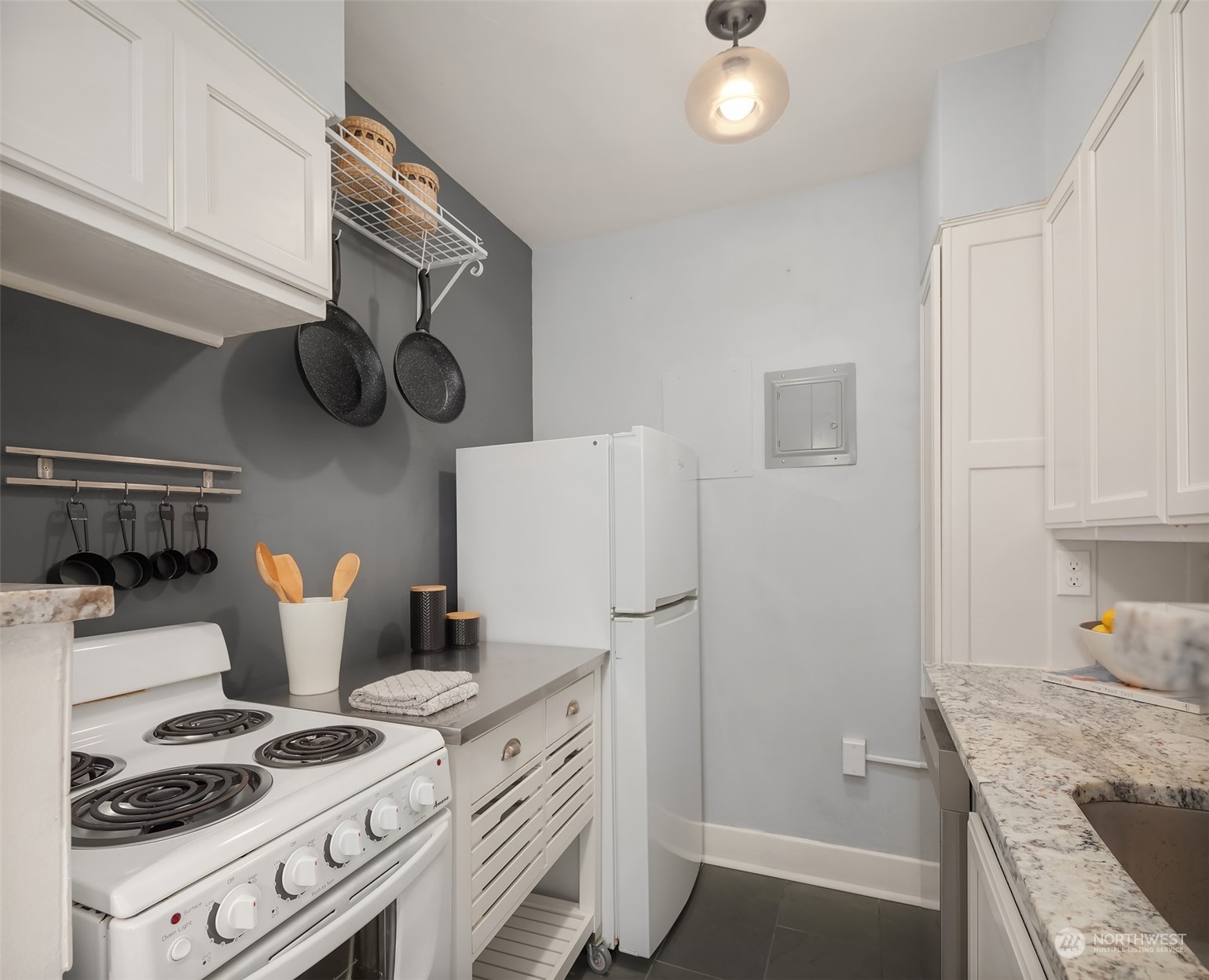 1605 East Olive Street, Unit 208 Seattle, WA 98122 - Photo 14 of 28 a kitchen with stainless steel appliances granite countertop a stove and a refrigerator