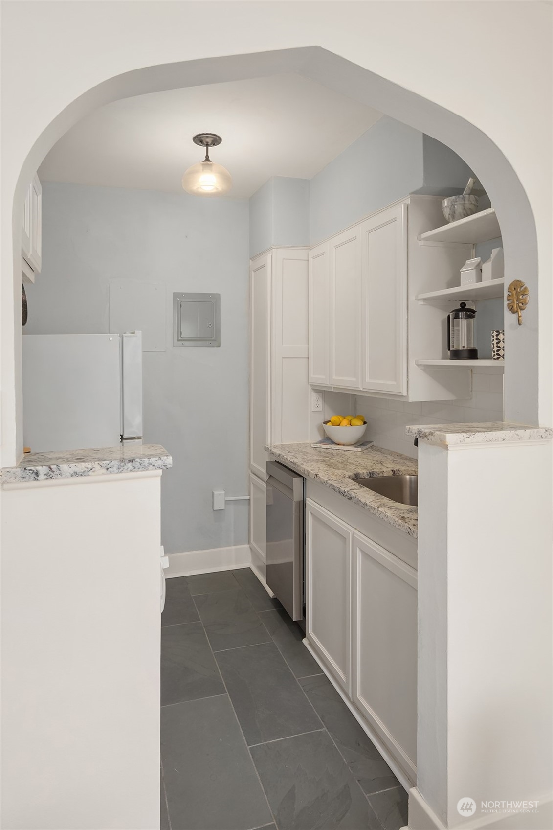 1605 East Olive Street, Unit 208 Seattle, WA 98122 - Photo 15 of 28 a kitchen with a sink stove and refrigerator