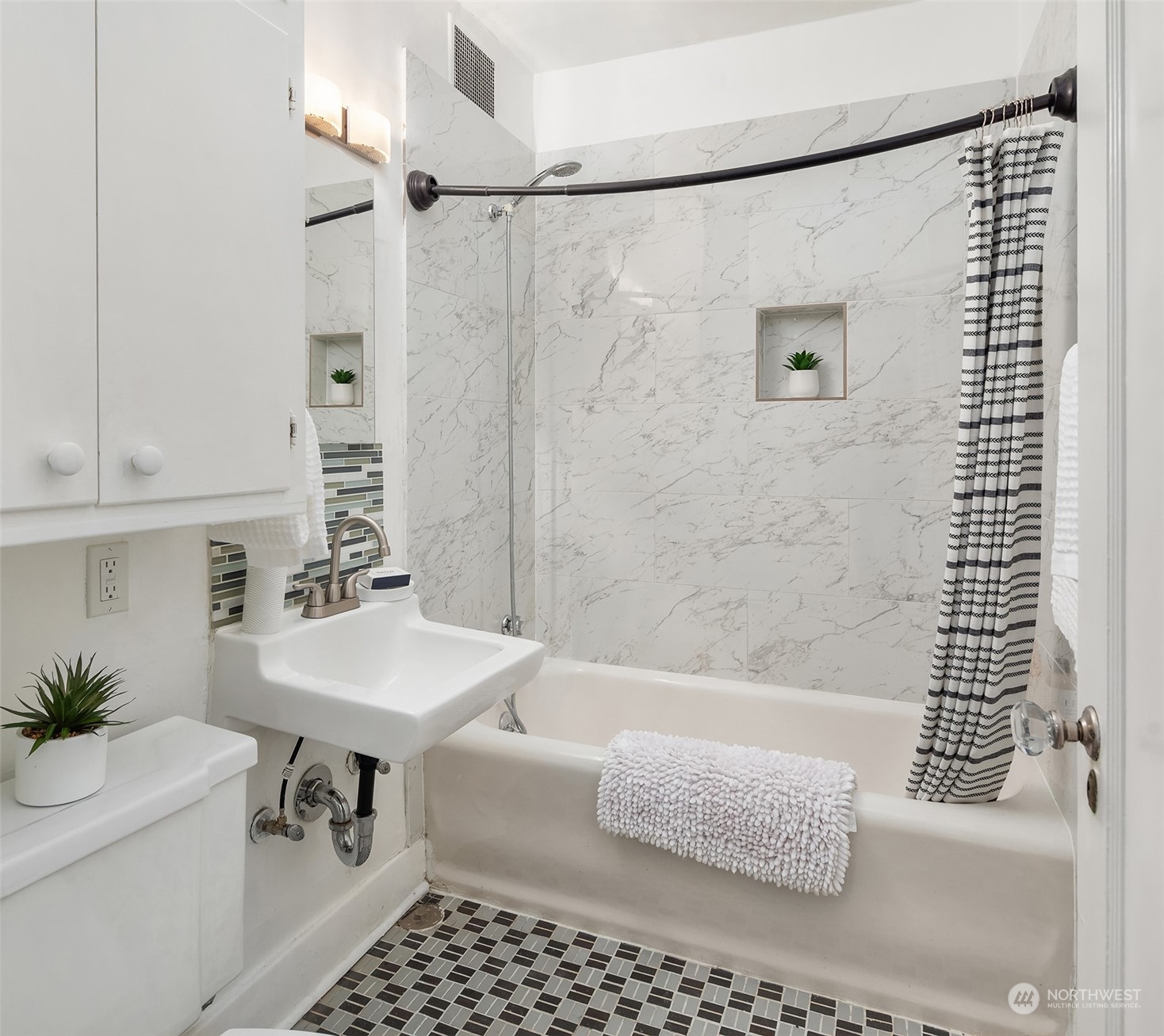 1605 East Olive Street, Unit 208 Seattle, WA 98122 - Photo 17 of 28 a bathroom with a sink a toilet a shower and a mirror