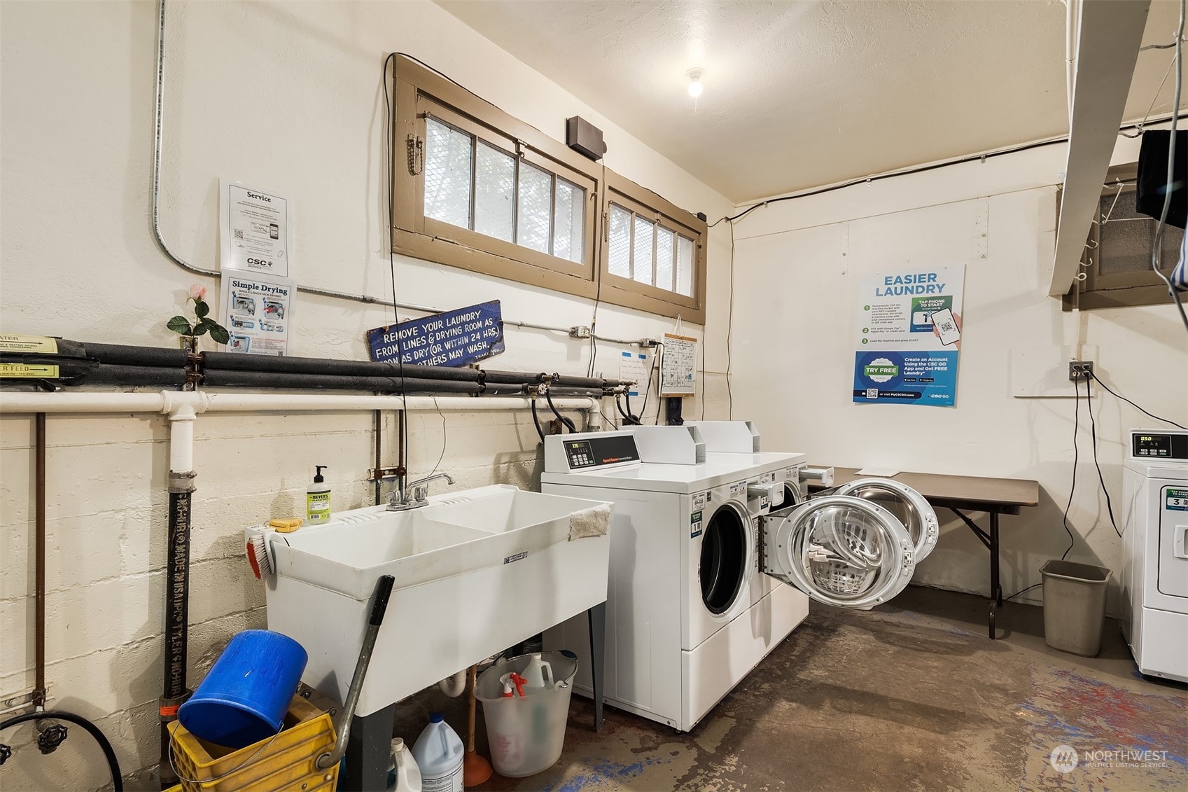 1605 East Olive Street, Unit 208 Seattle, WA 98122 - Photo 21 of 28 a utility room with a sink a washer and dryer