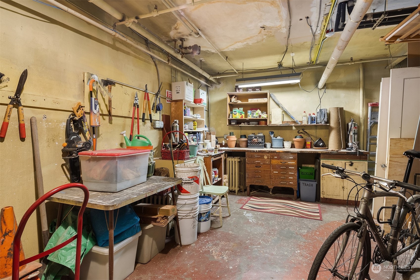 1605 East Olive Street, Unit 208 Seattle, WA 98122 - Photo 23 of 28 a view of a storage room with a table and chairs