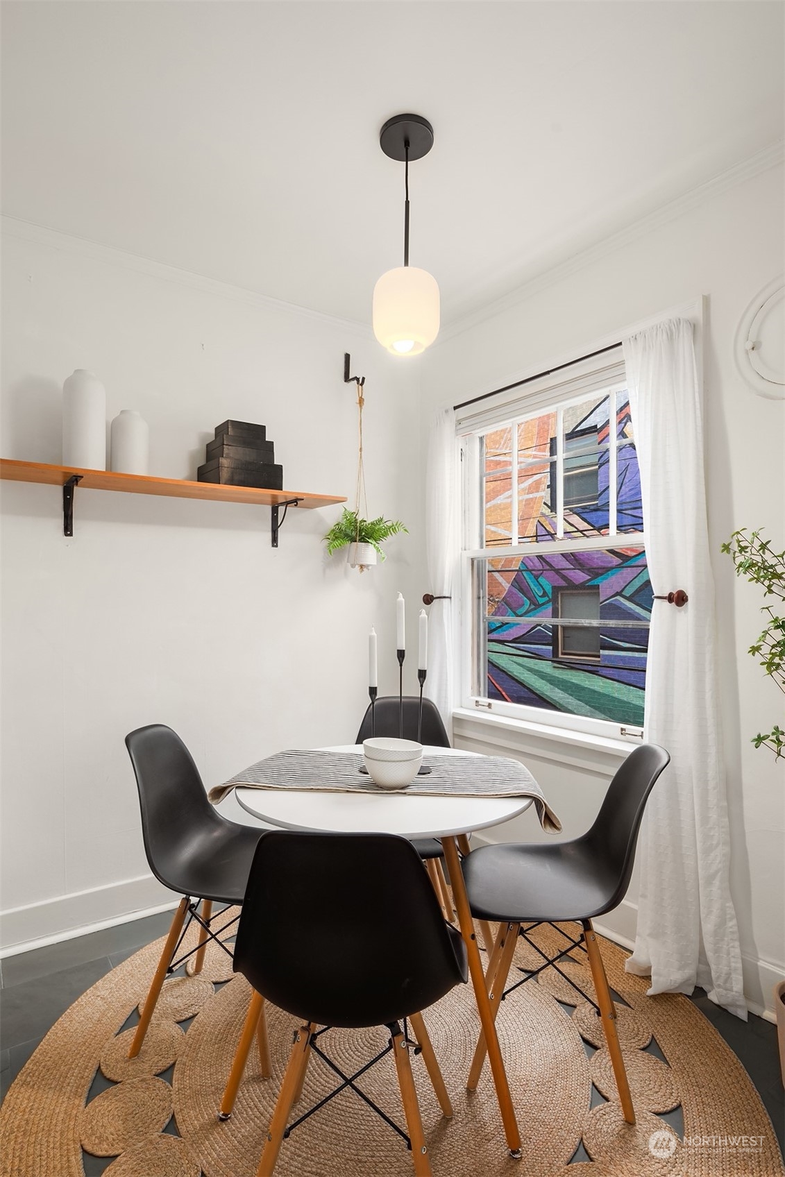 1605 East Olive Street, Unit 208 Seattle, WA 98122 - Photo 9 of 28 a view of a dining room with furniture and chandelier