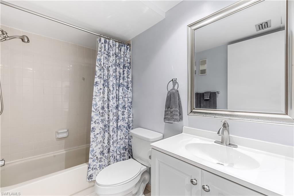 5841 Rattlesnake Hamm Road, Unit I101 Naples, FL 34113 - Photo 11 of 17 Full guest bathroom featuring vanity, shower / bath combo, and toilet