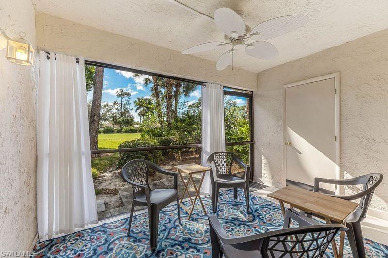 5841 Rattlesnake Hamm Road, Unit I101 Naples, FL 34113 - Photo 13 of 17 Screened lanai featuring ceiling fan, storage area, and amazing view of the golf course
