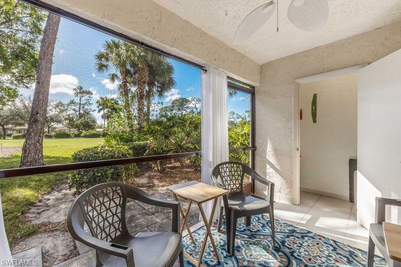 5841 Rattlesnake Hamm Road, Unit I101 Naples, FL 34113 - Photo 14 of 17 Screened lanai with ceiling fan, view of storage area, and view of golf course