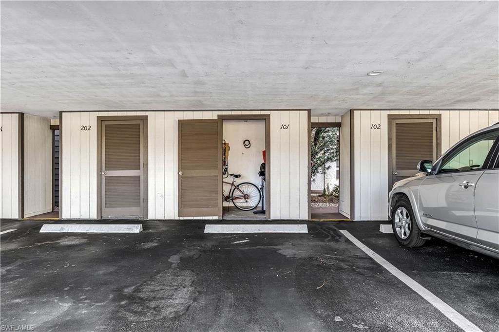 5841 Rattlesnake Hamm Road, Unit I101 Naples, FL 34113 - Photo 15 of 17 Assigned covered carport parking area with additional unit storage for bikes and beach gear.