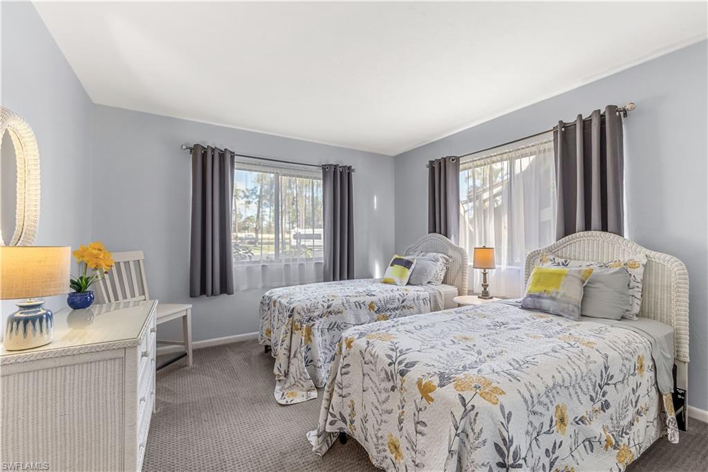 5841 Rattlesnake Hamm Road, Unit I101 Naples, FL 34113 - Photo 10 of 17 View of guest bedroom with newer carpet and twin beds