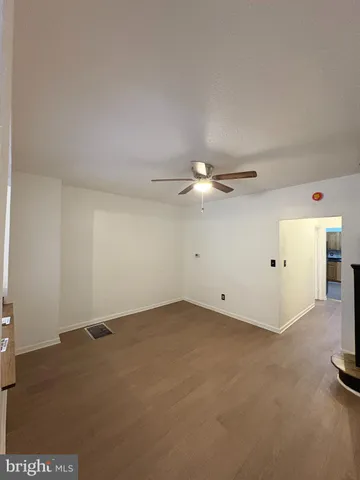 an empty room with a empty space and a ceiling fan