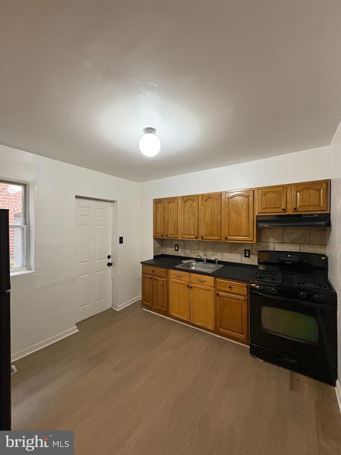 5504 Devon Street Philadelphia, PA 19138 - Photo 6 of 16 a kitchen with stainless steel appliances a stove a sink and a refrigerator
