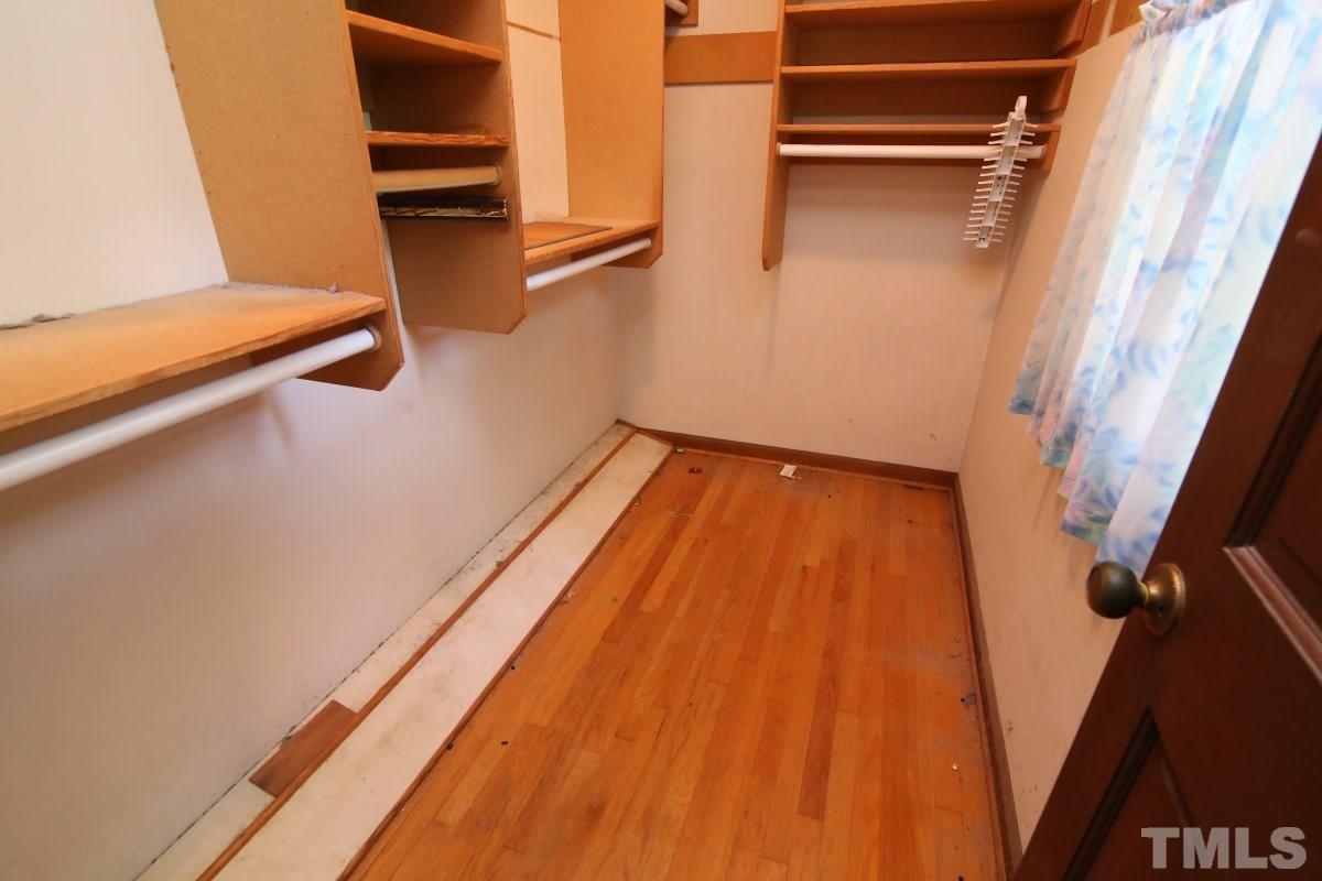 4508 Oak Park Road Raleigh, NC 27612 - Photo 16 of 24 a view of walk in closet with empty racks
