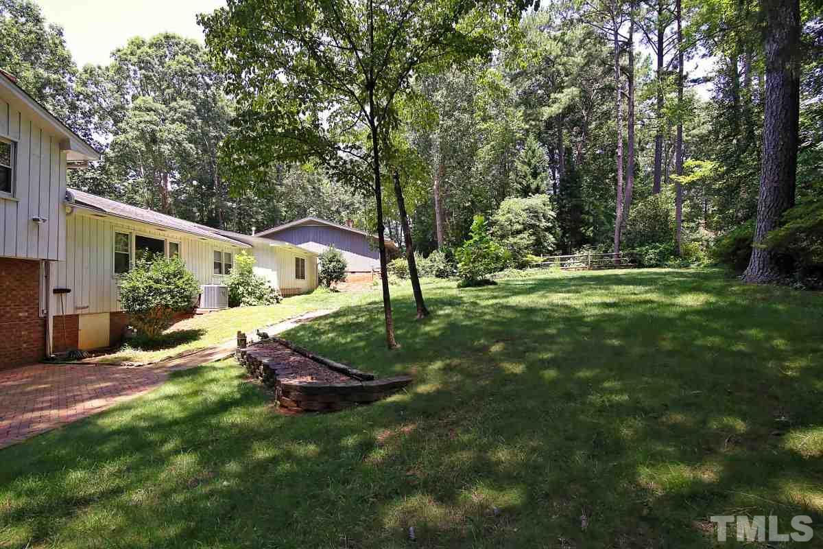 4508 Oak Park Road Raleigh, NC 27612 - Photo 20 of 24 a backyard of a house with table and chairs