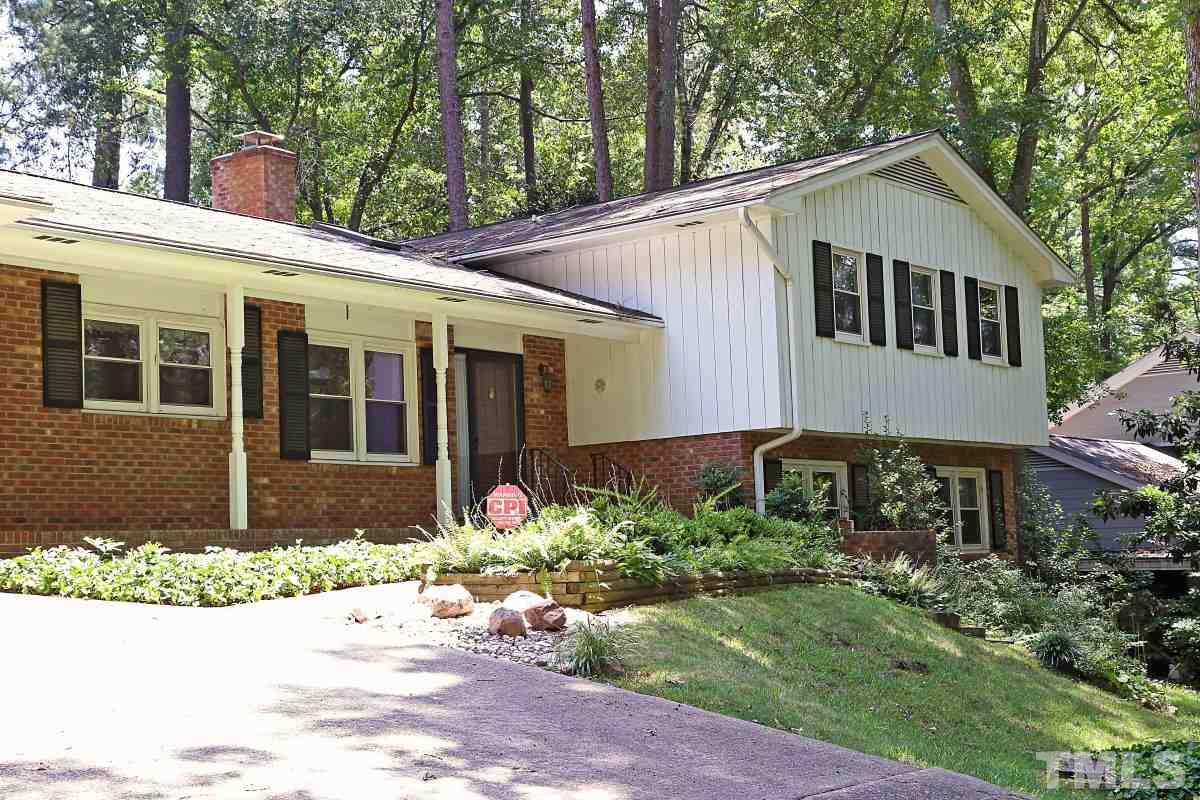 4508 Oak Park Road Raleigh, NC 27612 - Photo 3 of 24 a front view of a house with a yard and potted plants