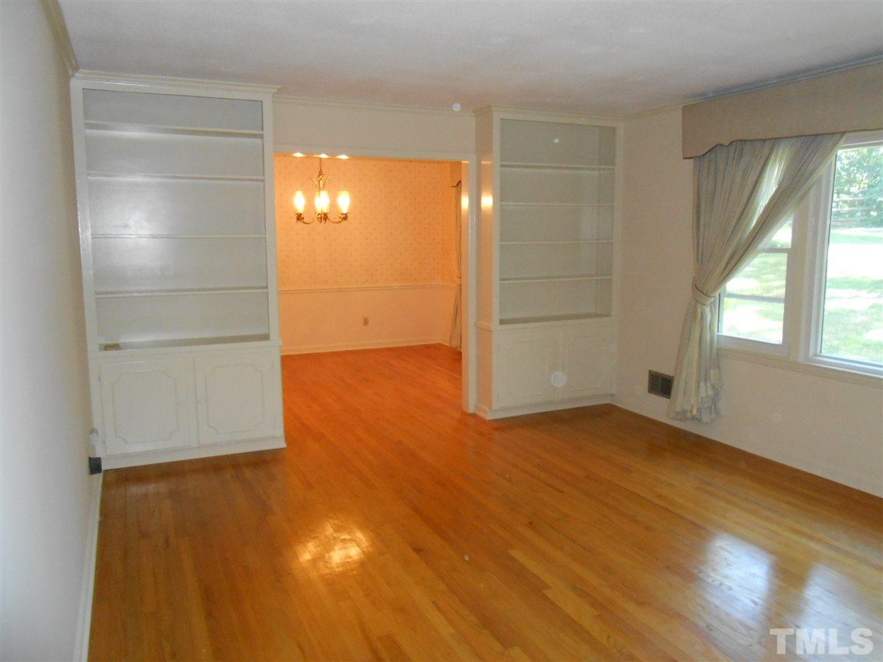 4508 Oak Park Road Raleigh, NC 27612 - Photo 7 of 24 an empty room with wooden floor and windows