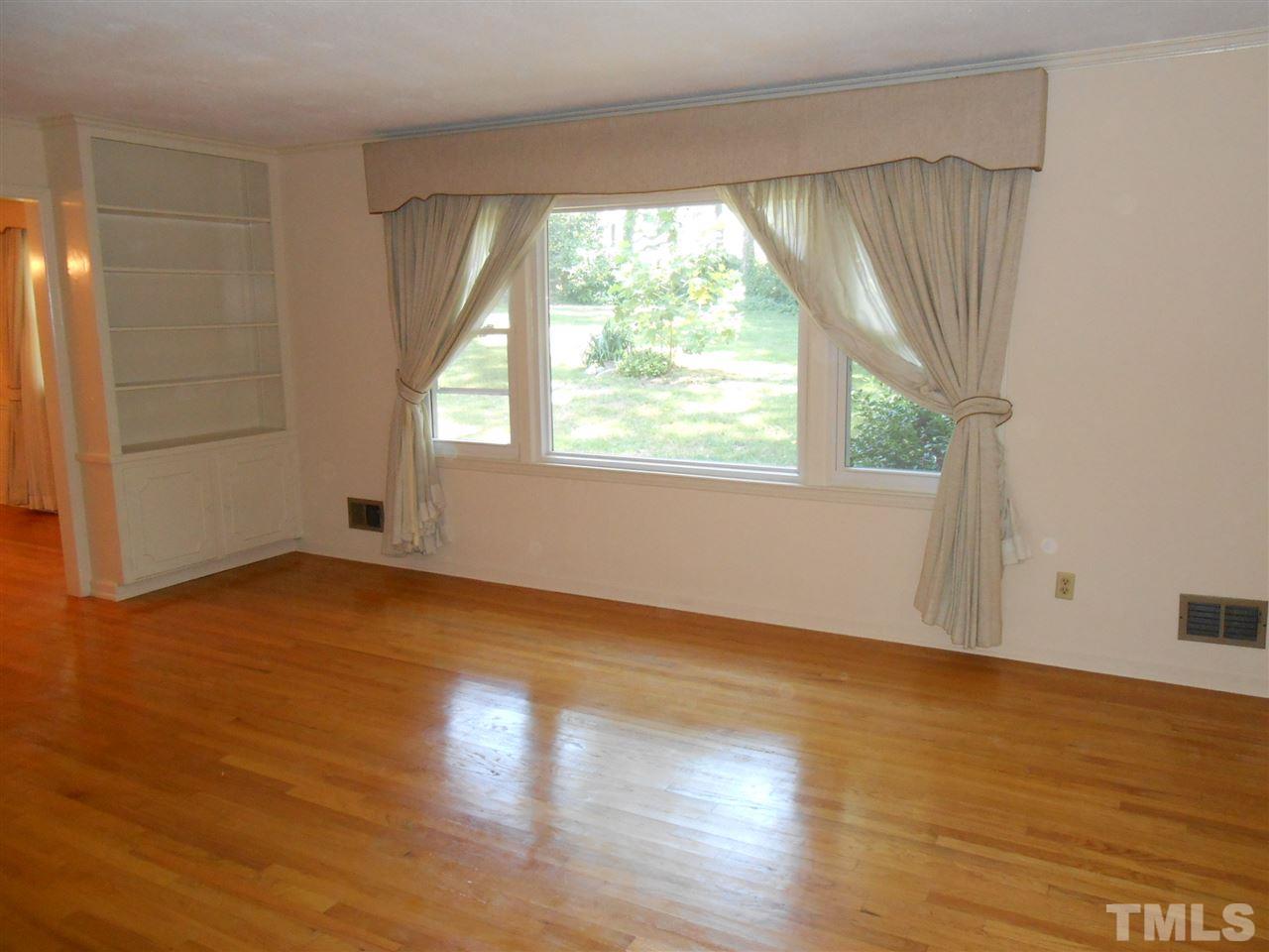 4508 Oak Park Road Raleigh, NC 27612 - Photo 8 of 24 an empty room with wooden floor and windows